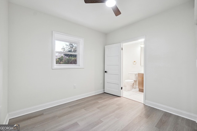 unfurnished bedroom featuring ceiling fan, light hardwood / wood-style floors, and connected bathroom