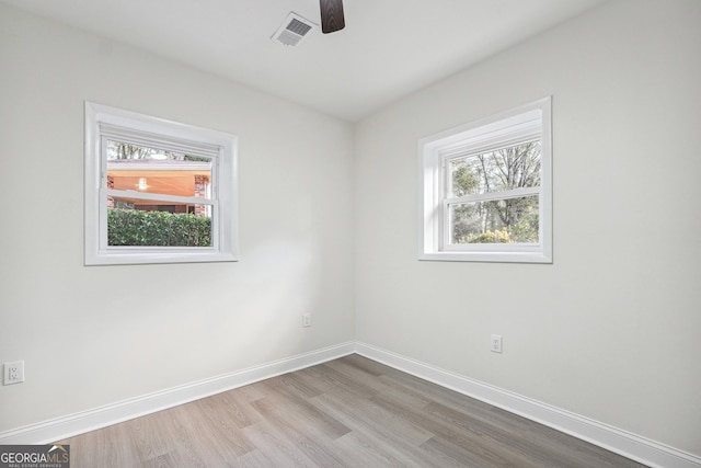 empty room featuring ceiling fan and light hardwood / wood-style flooring