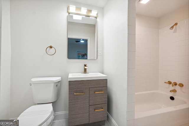 full bathroom featuring toilet, tiled shower / bath combo, and vanity