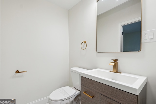 bathroom featuring toilet and vanity