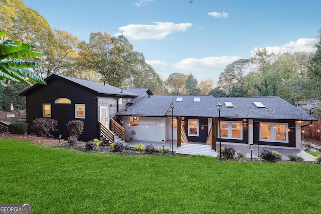 rear view of house with a yard