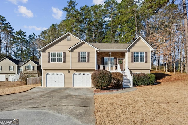 split foyer home featuring a garage and a porch