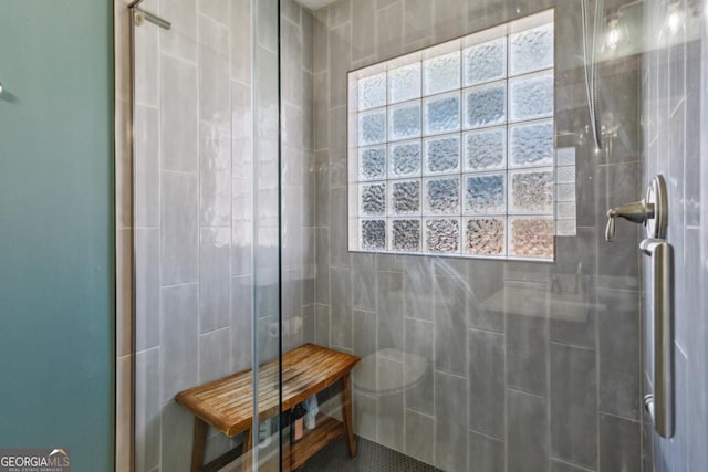 bathroom with an enclosed shower and toilet