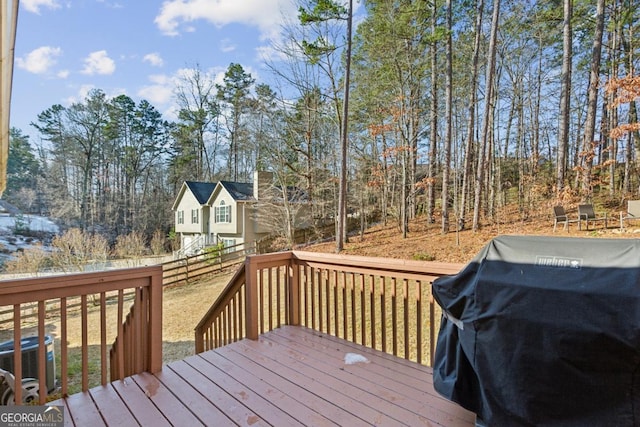 wooden terrace featuring central AC and grilling area