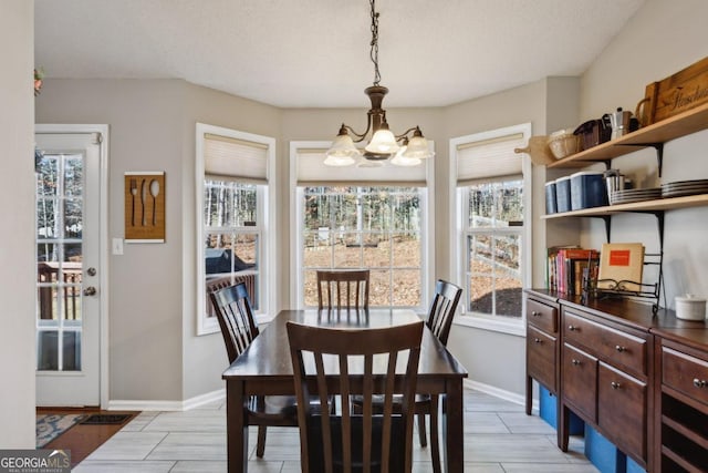 dining room featuring a textured ceiling and a chandelier