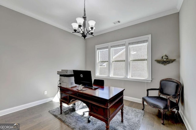 office space featuring a notable chandelier, ornamental molding, and wood-type flooring