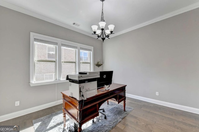 office area with an inviting chandelier, ornamental molding, and dark hardwood / wood-style flooring