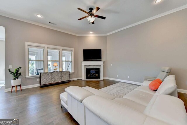 living room featuring ceiling fan, dark hardwood / wood-style flooring, and ornamental molding