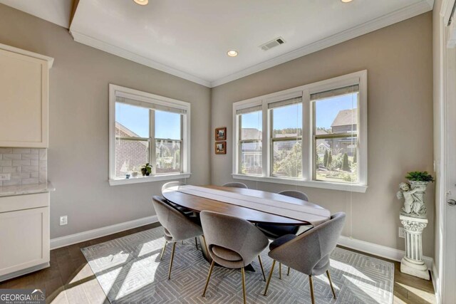 dining area featuring crown molding, a wealth of natural light, and dark hardwood / wood-style floors