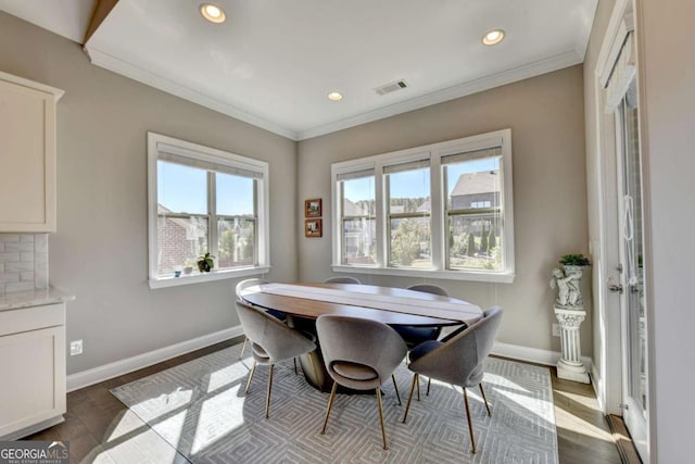 dining room with crown molding and dark hardwood / wood-style floors