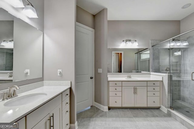 bathroom with vanity, tile patterned floors, and a shower with shower door