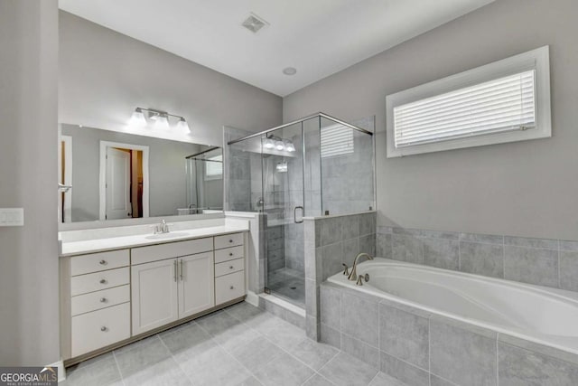 bathroom featuring independent shower and bath, tile patterned floors, and vanity