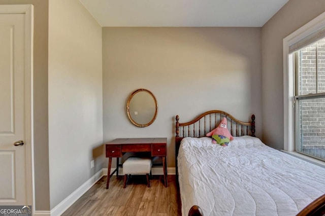 bedroom with wood-type flooring