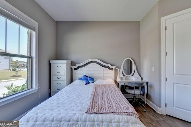 bedroom with dark wood-type flooring