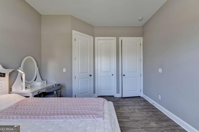 bedroom with dark hardwood / wood-style flooring