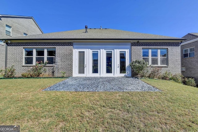 back of house featuring french doors and a yard