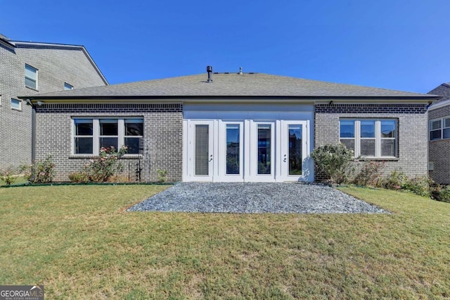 back of house featuring french doors and a yard