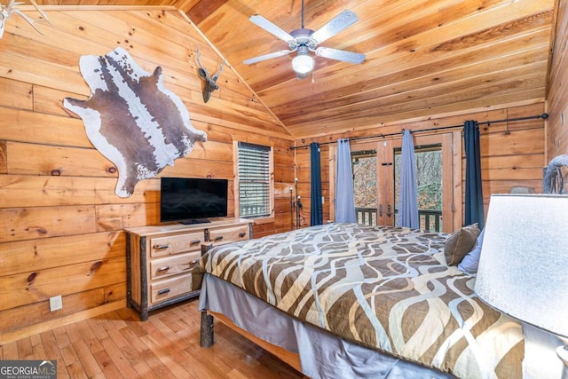 bedroom with wooden walls, ceiling fan, wood ceiling, and hardwood / wood-style floors