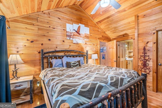 bedroom with lofted ceiling, wood walls, ceiling fan, and wood ceiling