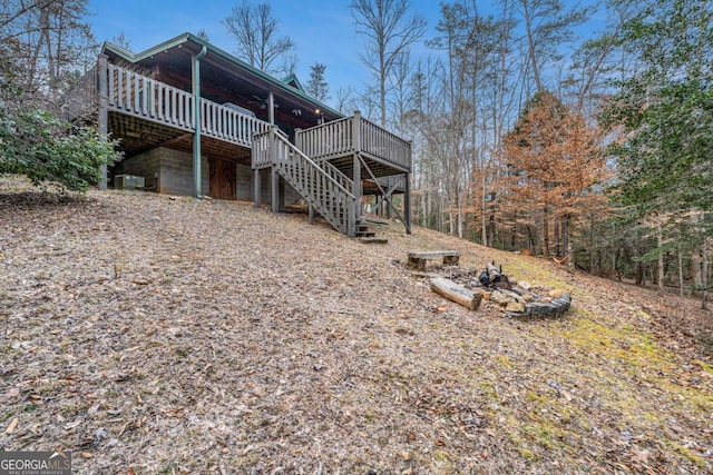 exterior space with a deck and an outdoor fire pit