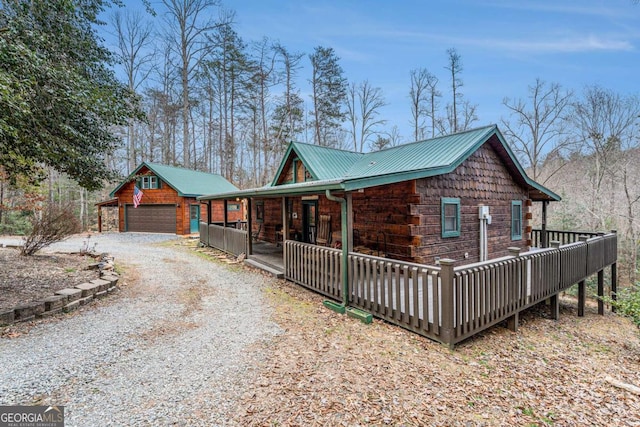 view of home's exterior with an outbuilding, covered porch, and a garage