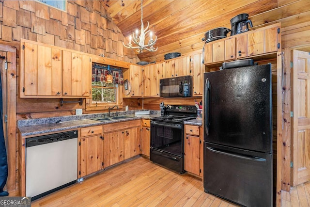 kitchen featuring a chandelier, pendant lighting, wood walls, black appliances, and lofted ceiling