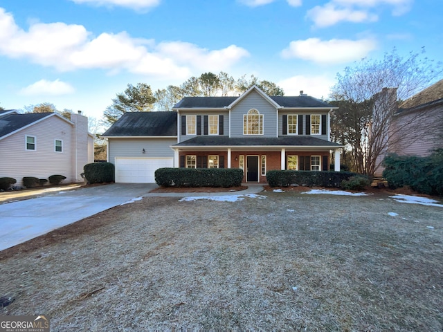 view of front of property featuring covered porch and a garage