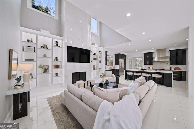 living room featuring a high ceiling and a premium fireplace