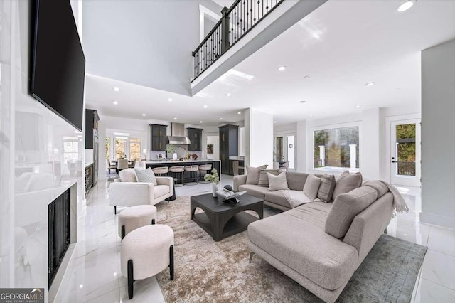 tiled living room featuring a premium fireplace