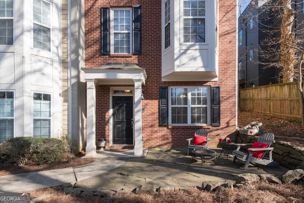 property entrance featuring a patio area