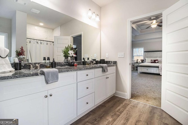 bathroom featuring ceiling fan, a shower with shower curtain, wood-type flooring, and vanity