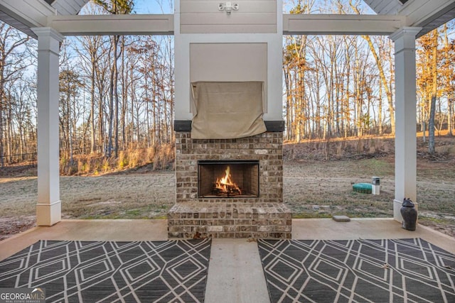 view of patio / terrace featuring an outdoor brick fireplace