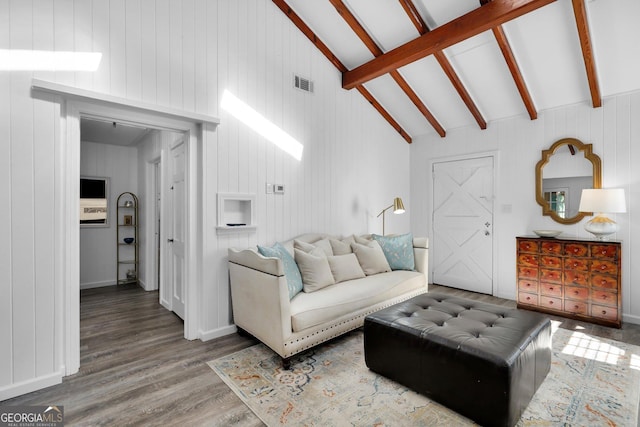 living room featuring hardwood / wood-style floors and lofted ceiling with beams