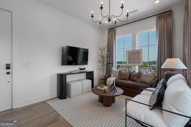 living room featuring light hardwood / wood-style flooring and a chandelier