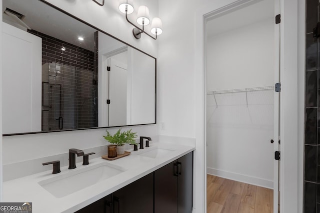 bathroom with an enclosed shower, vanity, and hardwood / wood-style flooring