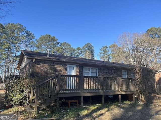 rear view of property with a wooden deck