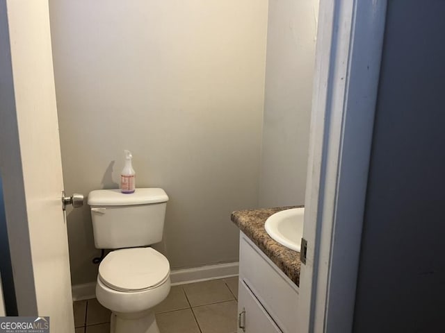 bathroom featuring toilet, tile patterned flooring, and vanity