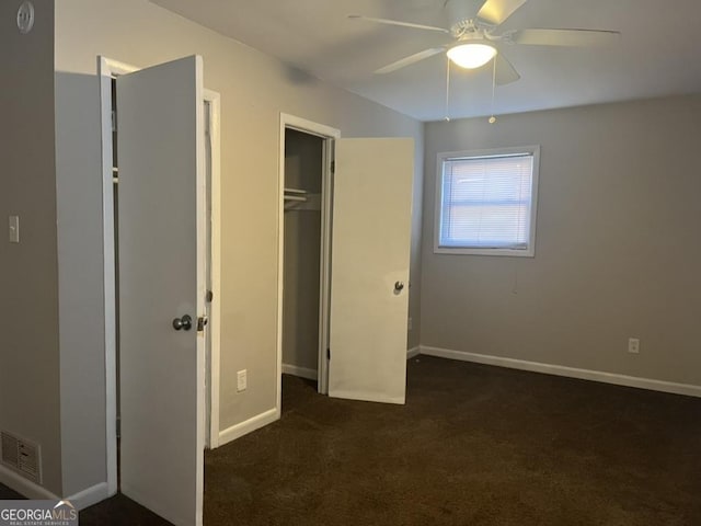 unfurnished bedroom featuring a closet, ceiling fan, and dark colored carpet