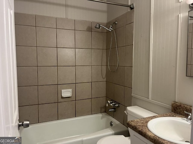 full bathroom with toilet, vanity, and tiled shower / bath