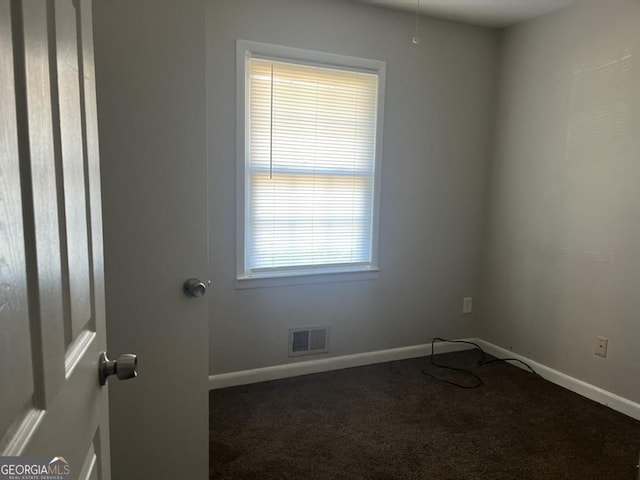 carpeted empty room featuring plenty of natural light