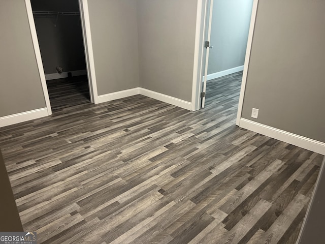 empty room with dark wood-type flooring