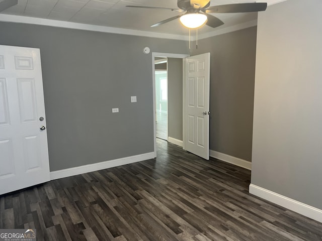 spare room featuring ceiling fan, ornamental molding, and dark wood-type flooring