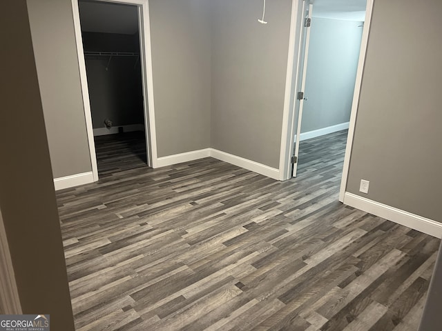 unfurnished room with dark hardwood / wood-style floors