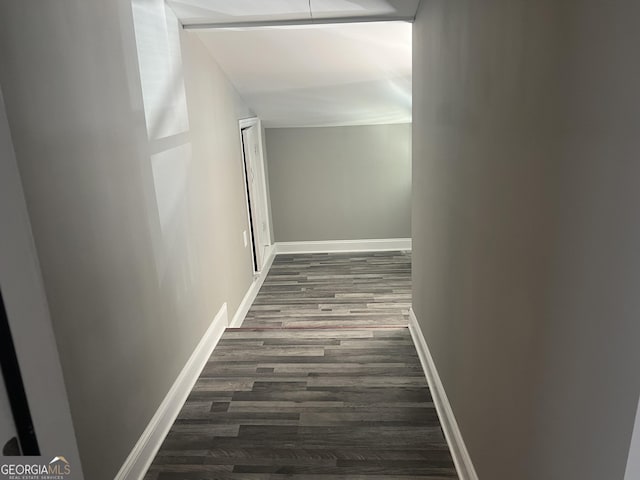 corridor with dark hardwood / wood-style flooring