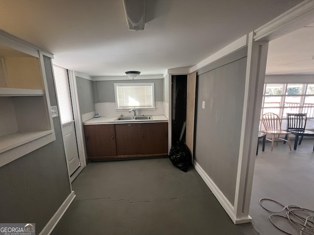 kitchen featuring sink and dark brown cabinets