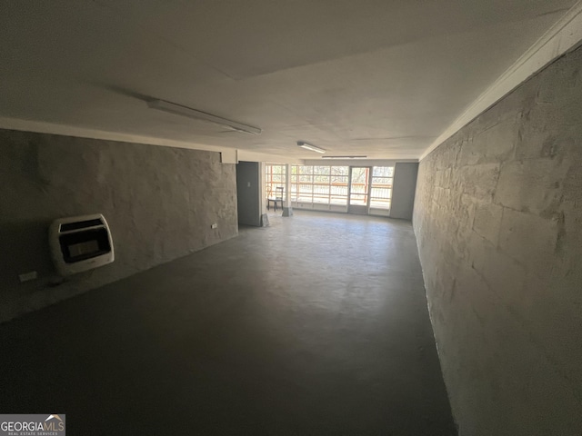 unfurnished room with concrete floors and heating unit