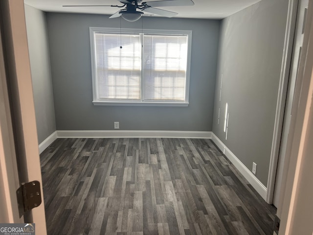 spare room featuring ceiling fan and dark hardwood / wood-style floors