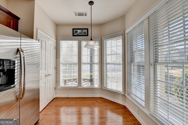 unfurnished dining area with light hardwood / wood-style flooring