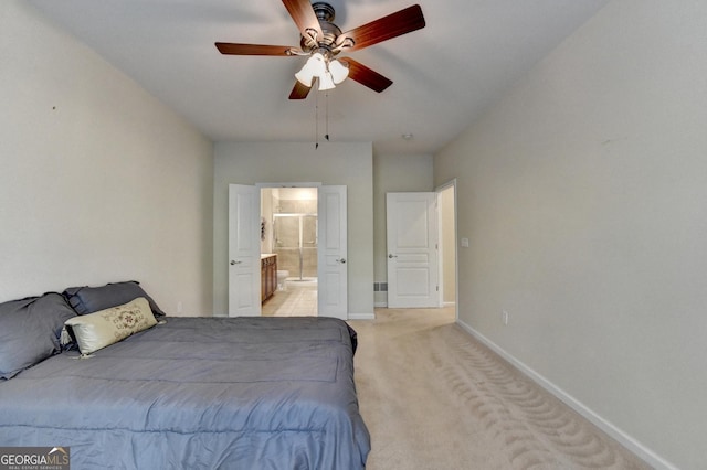 carpeted bedroom featuring ensuite bathroom and ceiling fan