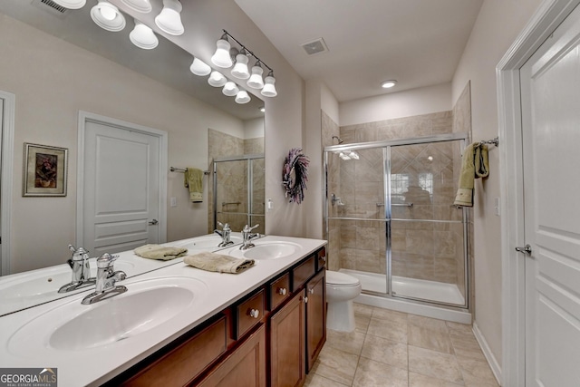 bathroom featuring toilet, tile patterned flooring, vanity, and a shower with shower door